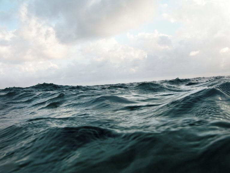 ocean wave water surface with cloudy sky